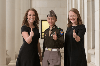 aggie women pose outside the academic buildin