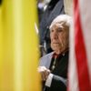 William Merriweather Peña ’42 sits between Belgian and American flags.