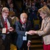 Princess Astrid congratulates former Aggie corpsman William Merriweather Peña ’42 after awarding him the Order of the Crown medal as the audience stood and applauded.