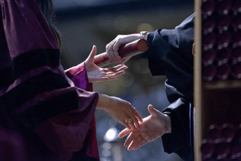 handing off diploma