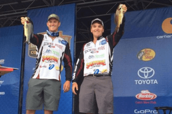 Matt McArdle (left) and Josh Bensema hold up the winning bass to capture the Bassmaster College Series National Championship title Saturday on Lake DuBay.