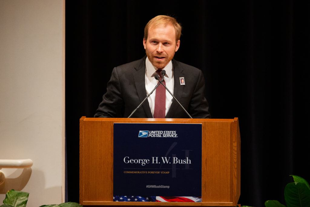 Pierce Bush, grandson of former President George H.W. Bush, speaks at the first-day-of-issue ceremony for the 41st president's Forever stamp.