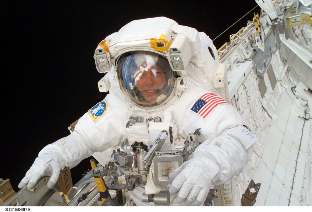 Michael E. Fossum works in Space Shuttle Discovery's cargo bay during the mission's third and final space walk July 13, 2006.