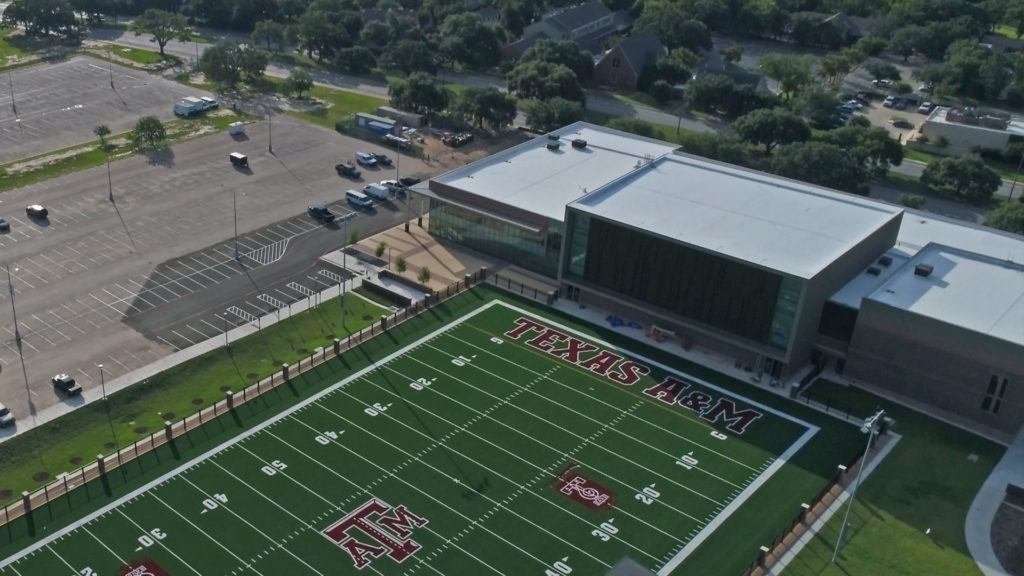 Aerial view of the Music Activities center with a turf practice field for the Aggie Band
