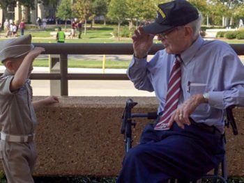 Ike Morris saluting a young boy dressed as a Texas A&M cadet