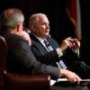 Former Texas A&M president Robert Gates talks on a stage while seated next to Bush School dean Mark Welsh