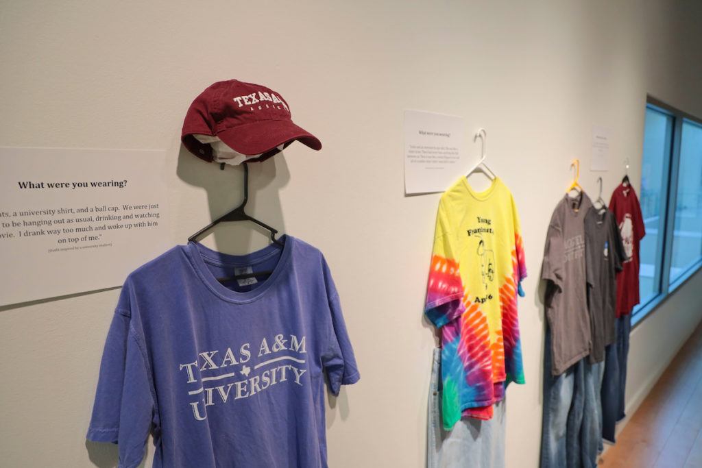 T-shirts and a cap hang on a wall