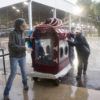 Veterinary Emergency Team members push dog washing station