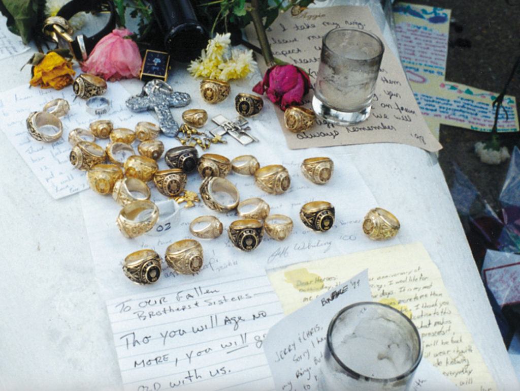The flagpole memorial featuring 31 Aggie Rings, flowers and letters