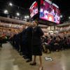 cadets stand in a line in reed arena at the front of the graduation ceremony