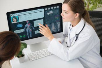 Doctor reviews healthcare records with patient