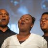 choir members singing on a stage