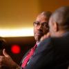 rueben may and marc lamont hill seated next to each other, talking