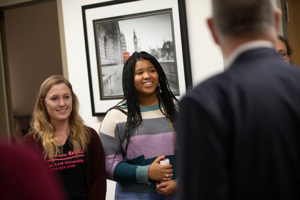 Texas A&M President Michael K. Young speaks with visitors at the grand opening of the new Student Services Building on Jan. 22.