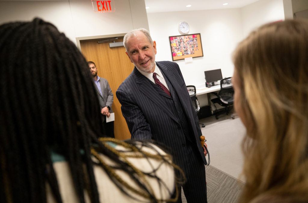 Texas A&M President Michael K. Young speaks with visitors at the grand opening of the new Student Services Building on Jan. 22.