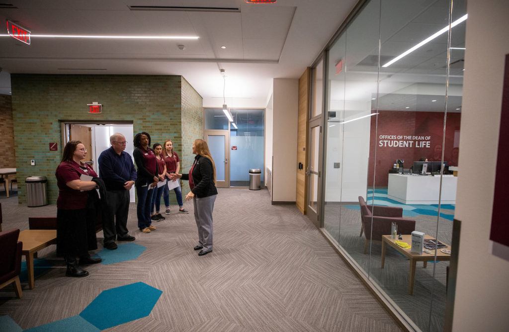 a group of people touring a room in the new building