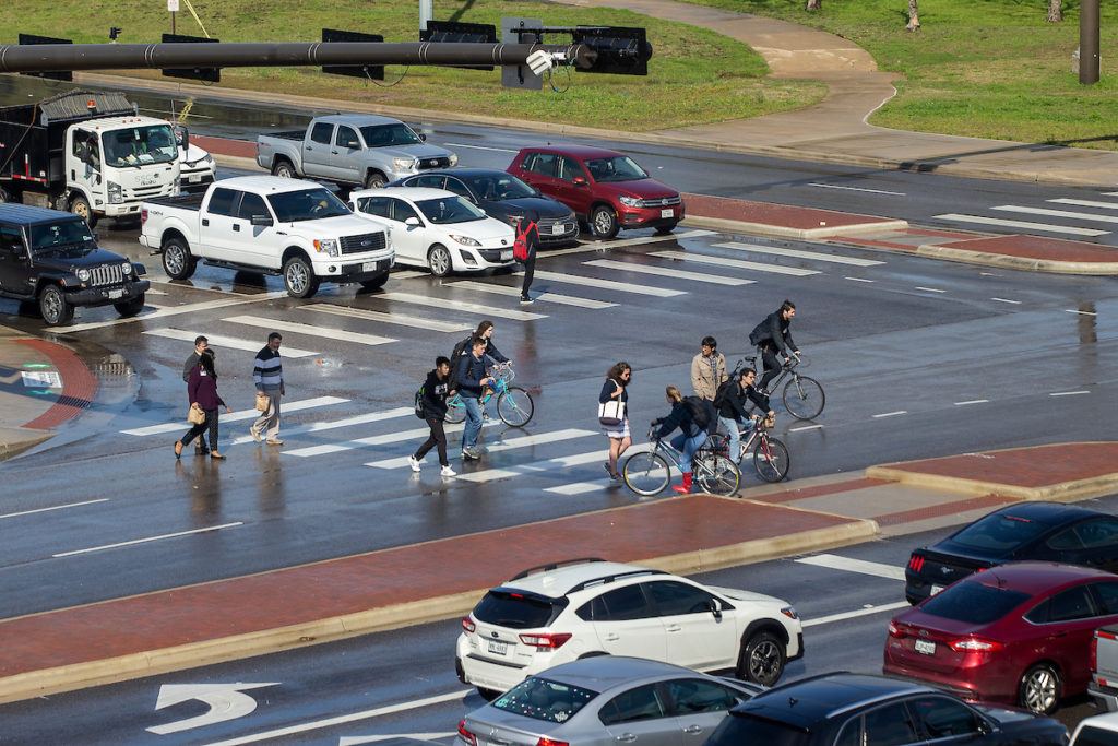 image of people walking through a crosswalk