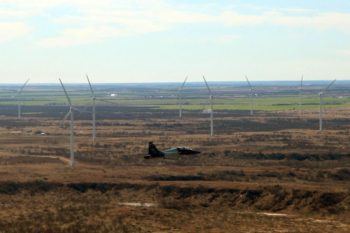A jet flies near wind turbines in West Texas.