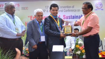 samba reddy holding a plaque at a conference