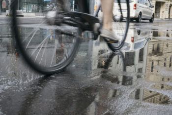 Close up view of a bicycle on a city street with cars in the background