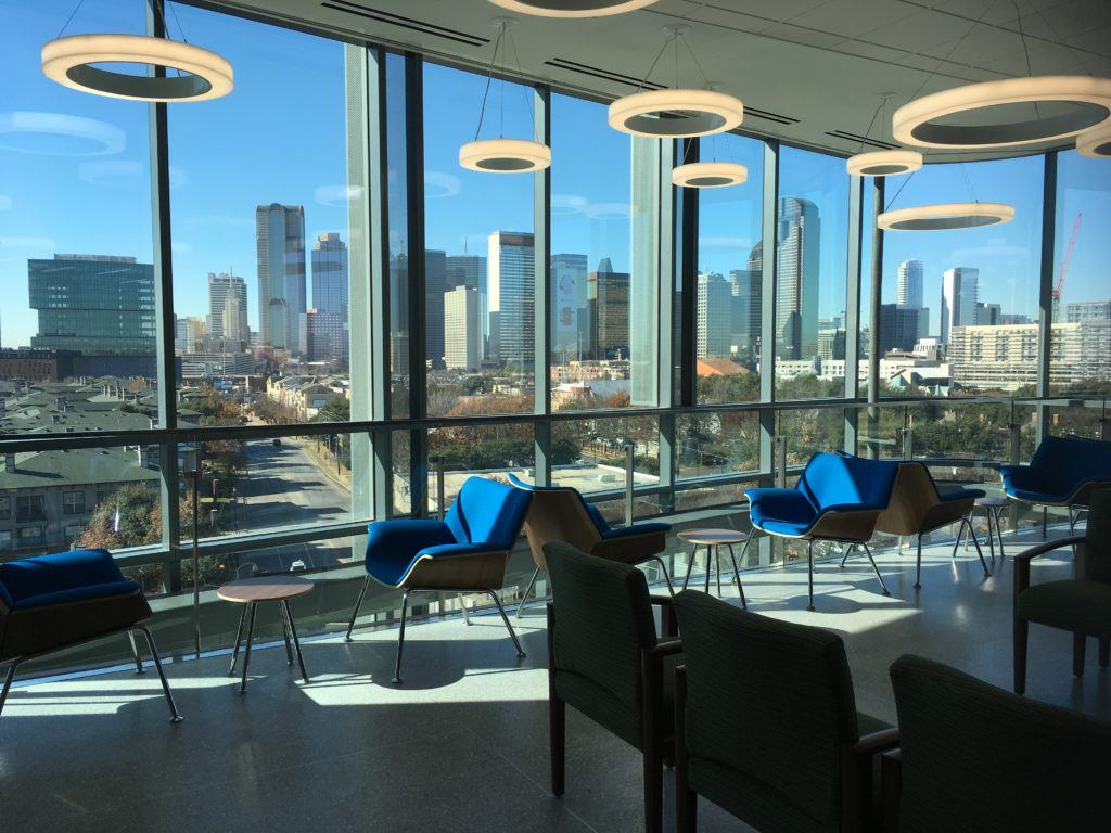 interior view of a waiting area in the new clinic building looking out on the dallas skyline