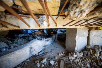 students crawling under rubble