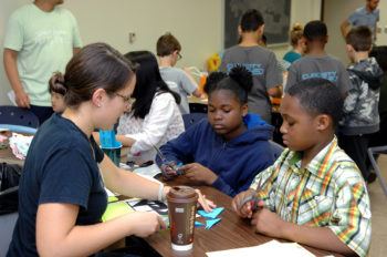 children sitting at tables doing math games