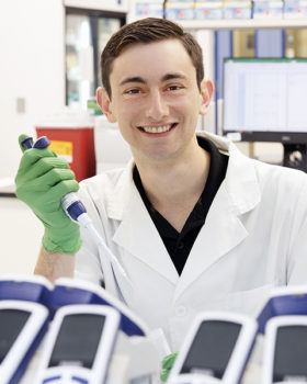 portrait of marshal covin in white coat and medical gloves holding a syringe