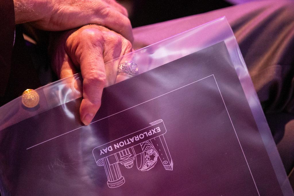 close up image of man's hand holding exploration day program
