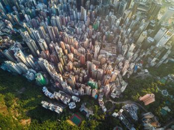 aerial view of a city with skyscrapers adjacent to trees