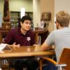 Two men sit across from each other and talk at the Human Library