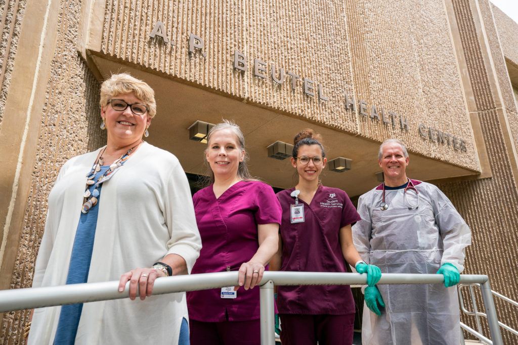 medical staff pose outside health center