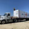a photo of a BUILD medical clinic on the bed of a truck being prepped to take to Houston
