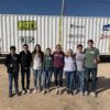 a photo of members of the BUILD student organization posing in front of the medical clinic