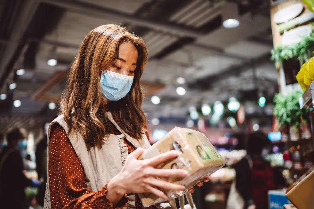 wp,an with medical face mask shopping for groceries in supermarket