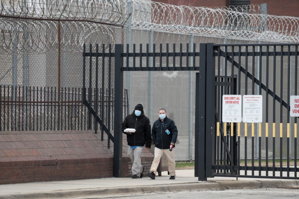 People wearing masks walking out of prison