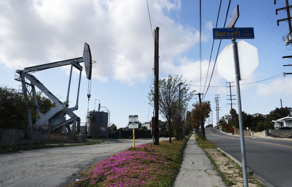 oil pumpjack in a neighborhood stands idle