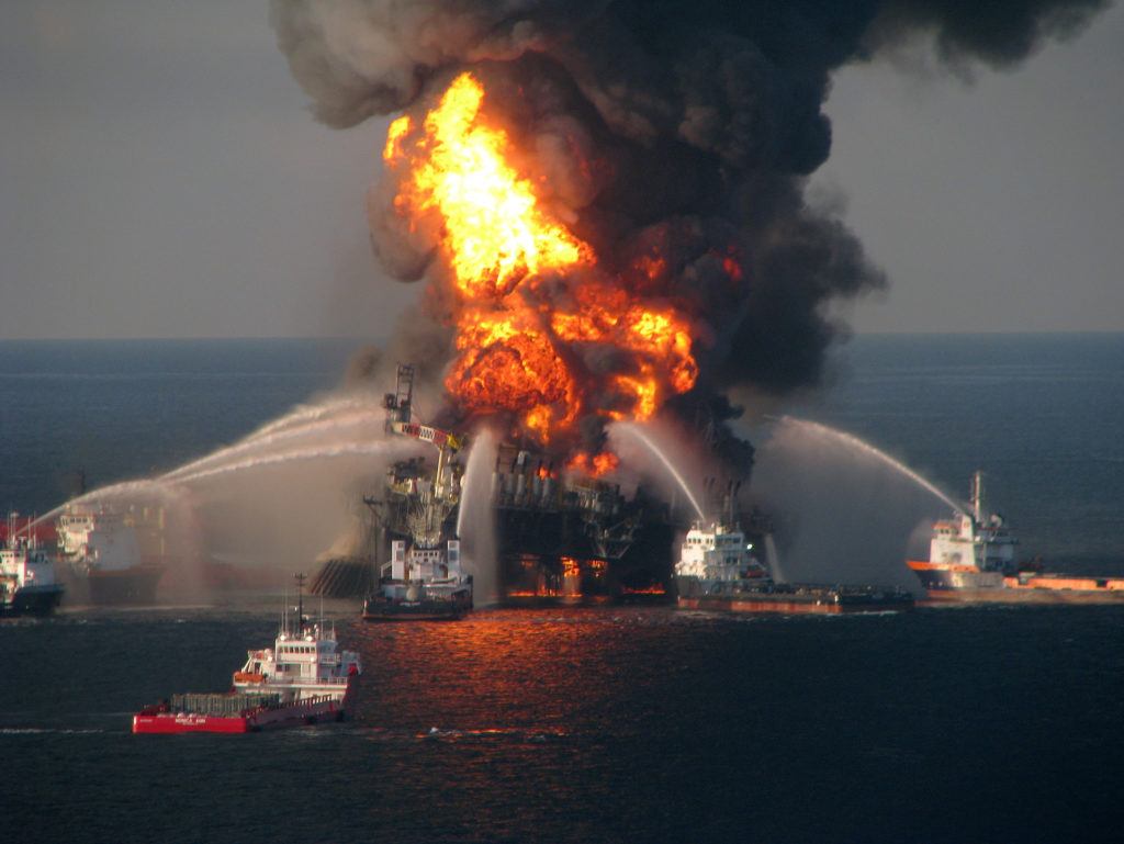 fire boats fight fire caused by an explosion on a flaming off shore oil rig