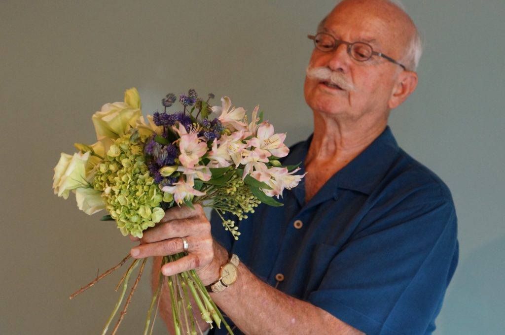 Jim JOhnson holding floral bouqet