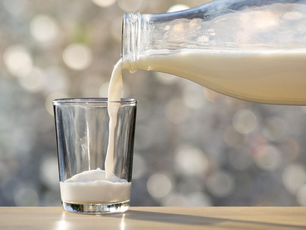 milk being poured into a glass