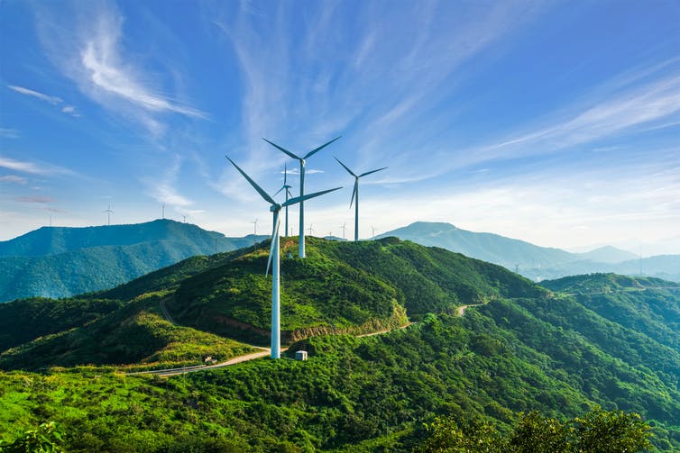 wind turbines in green hilly area
