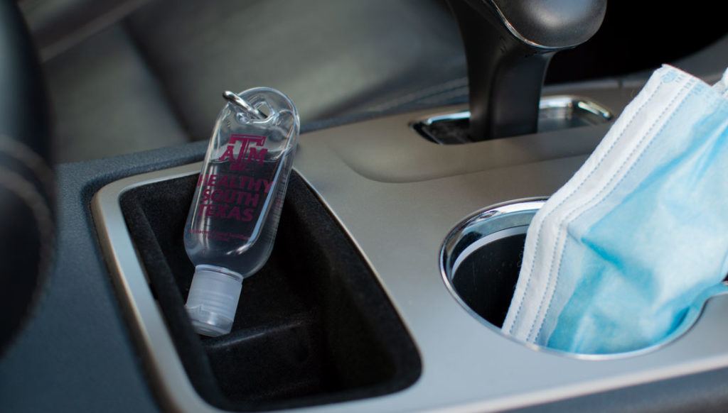 hand sanitizer in car cupholder