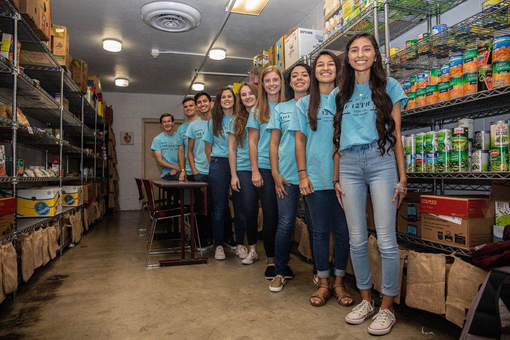 volunteers standing the the 12th can food pantry