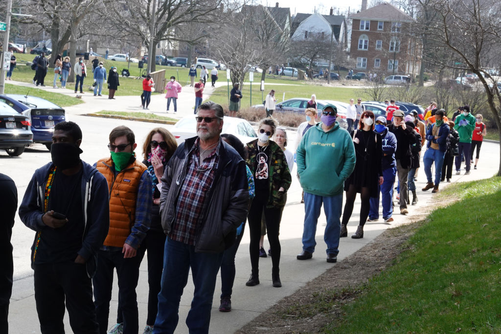 voters wait in long line outside a polling place