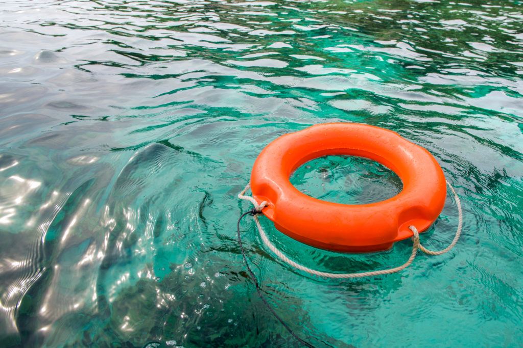 orange life ring floating on water
