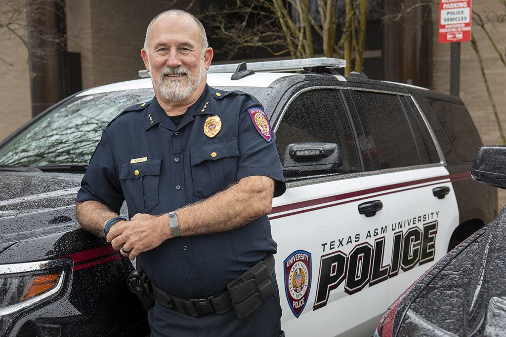 Mike Ragan leaning up against a UPD patrol car