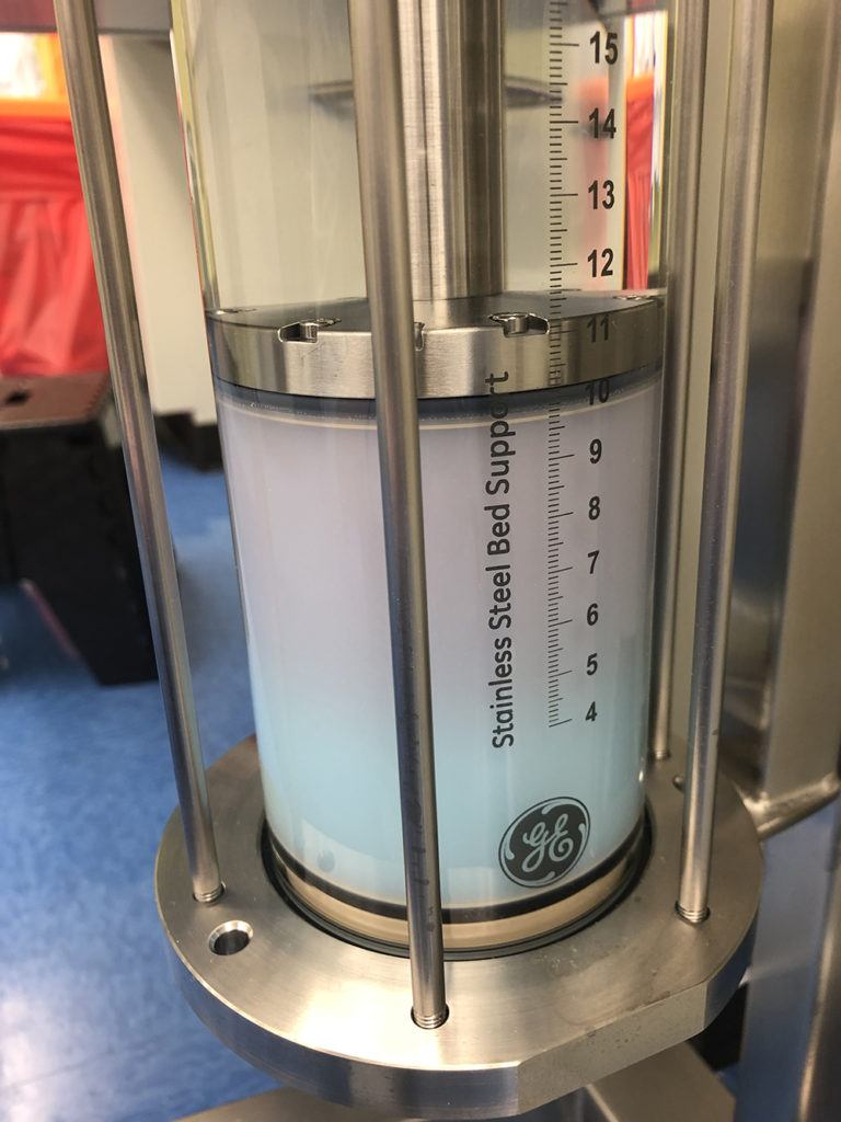 testing column filled with pink and green fluid