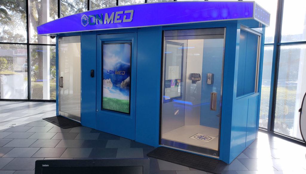 Blue enclosed kiosk sitting inside a building lobby