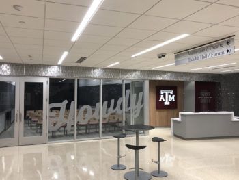 a photo of the newly renovated Visitor Center, including the front desk, theater and the word "Howdy" painted in large letters on glass