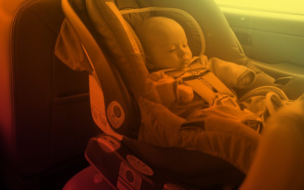 yellow and orange image of child sleeping in carseat